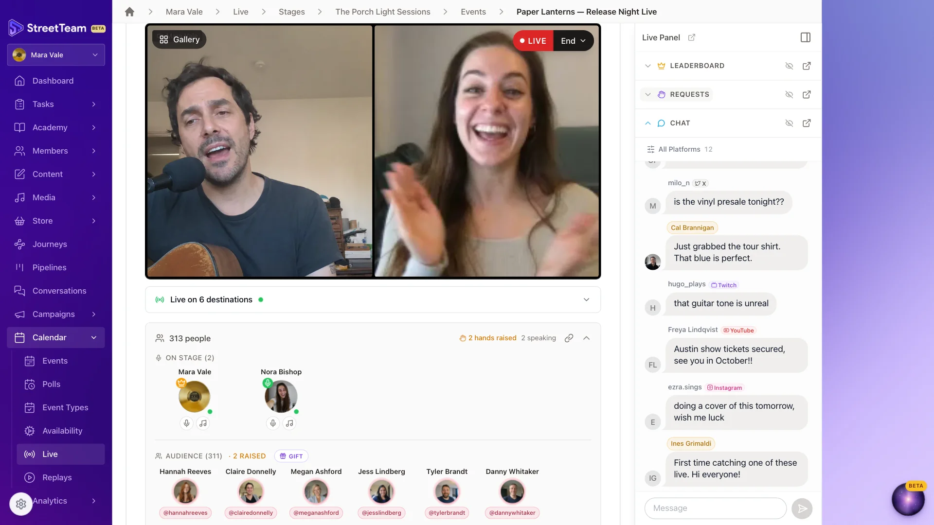 StreetTeam live stage host view with the artist performing on camera beside a fan brought on stage, a bar showing the stream is live on six destinations, an audience of 311 people, and comments from X, Twitch, YouTube, and Instagram merged into one chat