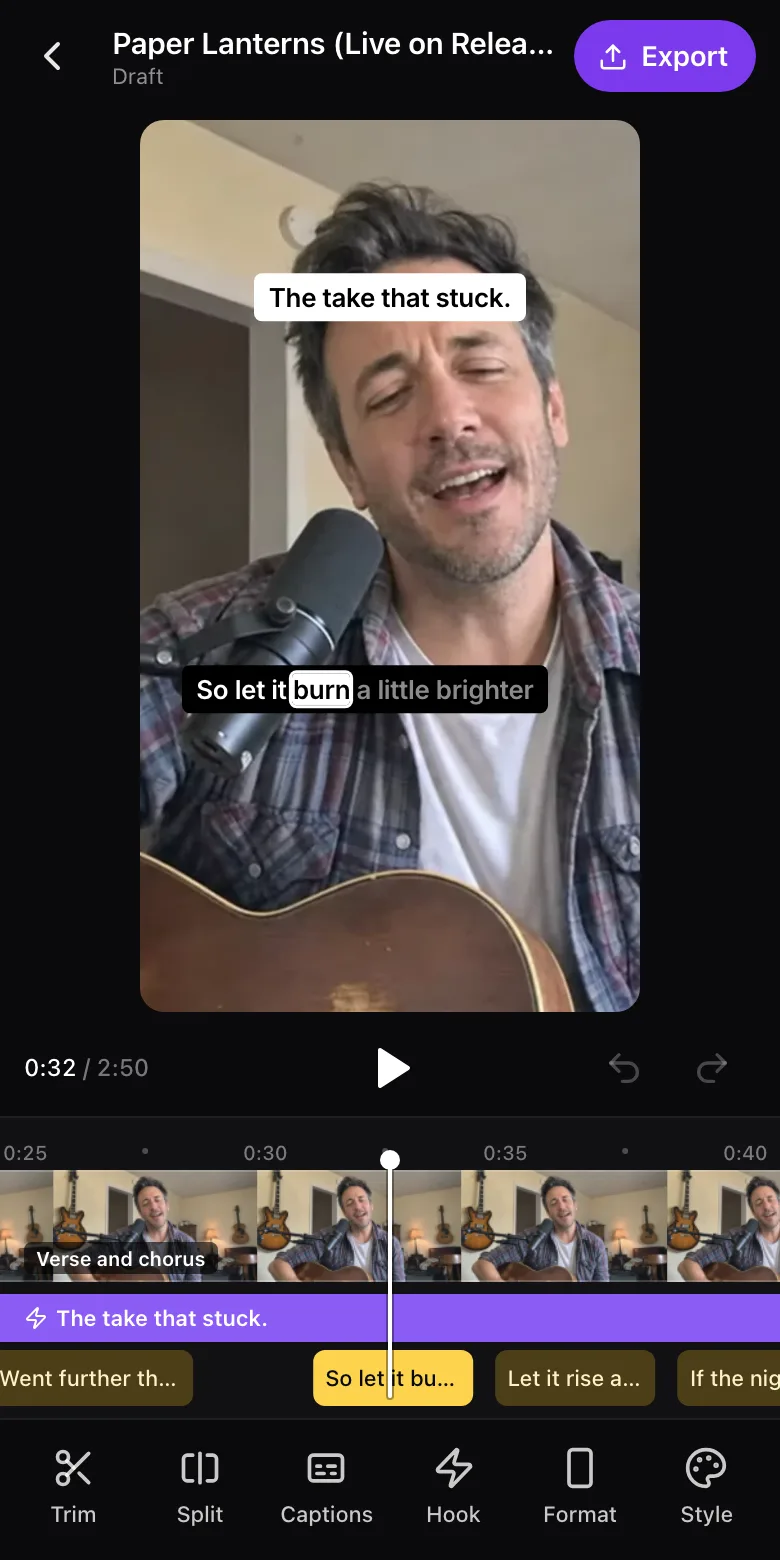 The StreetTeam Studio editor on a phone, editing a clip of Wes Callahan's live performance of Paper Lanterns: the vertical 9:16 picture of him singing into a microphone with his guitar, the hook "The take that stuck." across the top and a word-by-word lyric caption lighting up "burn" below, a play bar, a timeline with a filmstrip, the hook and caption lines under a fixed playhead, and a row of tools along the bottom: Trim, Split, Captions, Hook, Format and Style